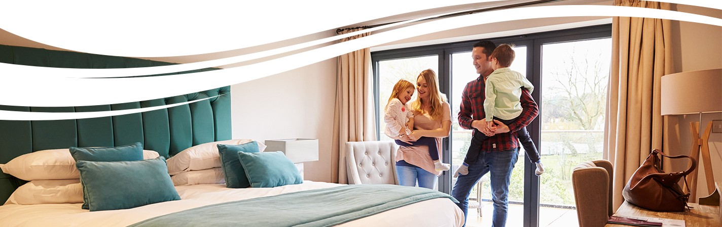 Couple with children checking into their hotel room in the Brazosport, Texas area.